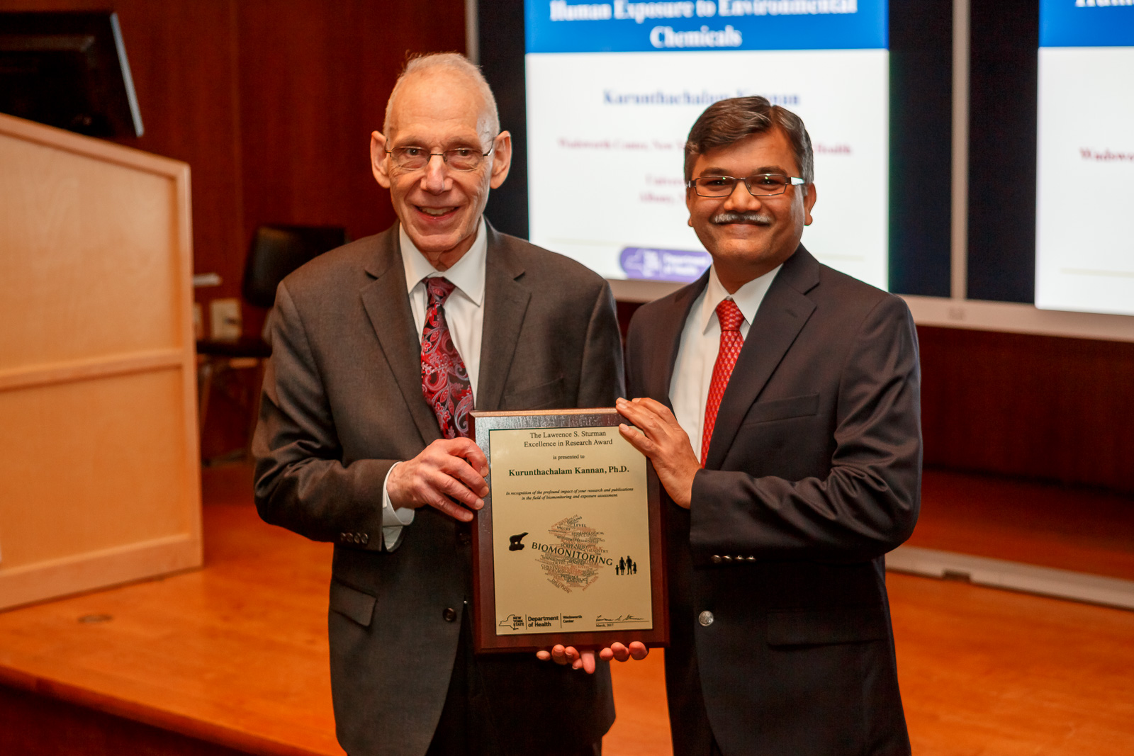 Dr. Kannan receiving award from Dr. Sturman